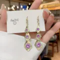 Sparkling gold dangle earrings with purple rhinestones in geometric rhombus design - Tiered Rhombus with Purple Stone Style (E3161) / Gold Purple