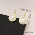 Elegant Korean style round earrings with pearlescent shell-like texture and gold finish - 粉白圆盘耳钩款(E2568金)