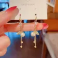 Elegant gold drop earrings with leaf design and pearl accents on display card - 金色叶子流苏耳坠(E2577金白)