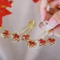 Sophisticated gold-tone dangle earrings with sparkling red maple leaf crystal charms - Red Maple Leaf Rhinestone Long Tassel Ear Clips (E2607金长款3叶耳夹)