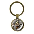 Vintage bronze metal keychain with piano keys and treble clef glass cabochon pendant - Antique Bronze