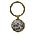 Llavero vintage de bronce de estilo industrial con frase I FIX STUFF y detalle de llave - Bronce Antiguo