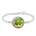 Close-up view of lucky four-leaf clover silver alloy bracelet with green glass cabochon - Lucky Clover Style 2 (XSWX6011-2)
