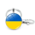 Detailed macro view of Ukraine flag glass dome keychain with silver lobster clasp - Ukraine