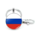 Detail of a metal keychain featuring the Russian flag design under a glass gem dome. - Russia