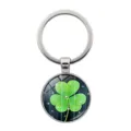 Detailed view of a silver metallic keychain featuring a vibrant green three-leaf clover. - Clover Style 8 (Silver-8)