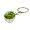 Detailed macro view of a silver keychain featuring a realistic four-leaf clover crystal ball - Green Field Clover (XSWX6005-12)