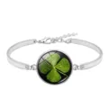 Macro detail of silver bracelet featuring a lucky four-leaf clover glass cabochon. - Lucky Clover Style 6 (XSWX6011-6)