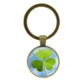 Antique bronze glass cabochon keychain with green shamrock clover design on sky background. - Clover Style 11 (Antique Bronze-11)