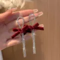 Close-up of elegant burgundy velvet bow earrings with long rhinestone tassels. - Bowknot Tassel Long Style (E1352) / Silver Plated Red