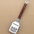 Stainless steel BBQ spatula with wooden handle and bottle opener, perfect for outdoor grilling dad gift. - BBQ Spatula