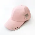 Pink baseball cap with metal rings and safety pin charms featuring a razor blade design. - Adjustable / Pink With Tool Pin