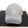Detailed view of a distressed gray baseball cap with white Lost in the moment 1989 embroidery - Adult 56-60cm / Gray