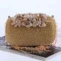 Elegant gold evening clutch bag featuring intricate rhinestone leaves and flower clasp decoration - 16x5x10cm / Gold