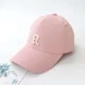 Detailed side view of a stylish pink baseball cap featuring a white embroidered letter R - Adult 55-59cm / Pink