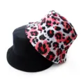Detail shot of the reversible bucket hat showing black and pink leopard print sides. - Adult 55-58cm / Leopard Red