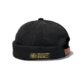 Macro view of black corduroy brimless miki hat with a vintage side woven label - Adult 55-58cm / Black