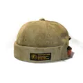 Side view of olive green corduroy docker hat featuring a vintage black and gold embroidered patch - Adult 55-58cm / Army Green