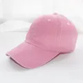 Close-up detail of a solid pink washed cotton baseball cap showing fine brim stitching. - Adult 55-59cm / Pink