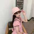 Stylish pink bucket hat worn by a model in a minimalist lifestyle setting - Adult 56-58cm / Bucket Hat Style / Pink