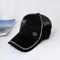 Black baseball cap with gold piping and metal M logo detail for stylish street wear and sun. - Adult Adjustable 55-59cm / Black