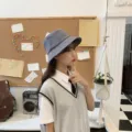 Close-up side view of a young woman wearing a minimalist light grey summer cotton bucket hat - Adult 56-58cm / Bucket Hat Style / Gray