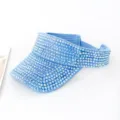 Dettaglio di una visiera in denim azzurro completamente ricoperta di strass iridescenti. - 55-58cm / Blu