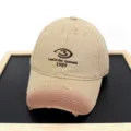 Detailed view of distressed khaki baseball cap with 'Lost in the moment' embroidery - Adult 56-60cm / Khaki