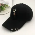 Minimalist black baseball cap featuring a metal star pendant and three iron rings on brim - Black