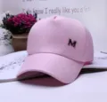 Stylish pink baseball cap for women featuring a metal M logo and a curved brim - Adjustable / Pink