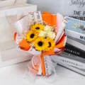 Detailed view of artificial sunflower and rose bouquet with orange wrapping paper - Gypsophila Sunflower (With Light Bag) / Orange