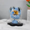 Close-up of blue soap roses and sunflower bouquet inside a transparent glass dome - Ice Blue