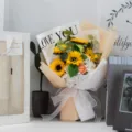 Beautiful artificial sunflower bouquet with eucalyptus leaves in LOVE YOU printed wrapping paper - Sunflower Rose Mix (With Light Bag) / Champagne