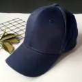 Detailed view of a navy blue cotton baseball cap with a structured crown and curved brim - Adult Adjustable 55-59cm / Navy Blue
