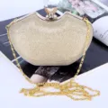 Elegant gold glitter evening clutch bag for women with rhinestone closure and chain strap. - Gold