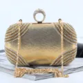 Gold satin evening clutch bag with sparkling rhinestones, unique ring handle and metal chain. - Gold