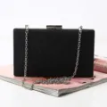 Elegant black evening clutch bag with silver chain strap, perfect for parties and formal events. - 20cm x 4cm x 12cm / Black