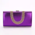 Purple metallic evening clutch bag with U-shaped rhinestone embellishment and metal clasp. - Purple