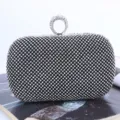 Elegant black rhinestone evening clutch bag featuring sparkling crystal ring handle for parties. - Black