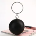 Elegant black spherical evening clutch bag with a shimmering rhinestone ring handle - 12cm / Black