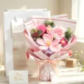 Detailed macro view of a handmade pink crochet flower bouquet with gift bag and cards - Pink Tulip, Heart, Rose, Gift Bag