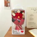 Crochet knitted flower bouquet in transparent gift box handmade home decor detail view - Gelsang Flower Bouquet + 4 Puff Flowers + Handheld Gift Box / Red