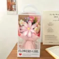 Detail view of handmade crochet flower bouquet in transparent gift box, elegant gift. - Gelsang Flower Bouquet + 4 Puff Flowers + Handheld Gift Box / Pink