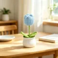 Detailed shot of a handcrafted light blue crochet tulip in a white ceramic pot - Single Head Tulip - Blue