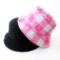 Detailed view of reversible bucket hats in solid black and pink gingham pattern - Adult 55-58cm / Pink Square