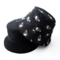 Close-up detail shot of the reversible bucket hat showing solid black and skull pattern. - Adult 55-58cm / Skull Black