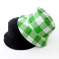 Reversible bucket hat featuring solid black side and green checkered pattern detail - Adult 55-58cm / Square Green