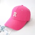 Close-up of bright pink baseball cap featuring a white embroidered letter R detail. - Adult 55-59cm / Rose Red