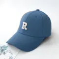 Stylish blue baseball cap featuring a white embroidered letter R on the front panel - Adult 55-59cm / Dark Blue
