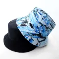 Reversible bucket hat featuring solid black and blue splatter print design for casual wear. - Adult 55-58cm / Graffiti Blue